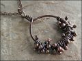 Necklace featuring dark clusters of molten copper