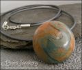 Polymer clay dome shaped pendant on PVC thong necklace