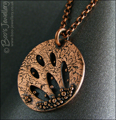 Textured copper pendant drizzled with tiny raindrops