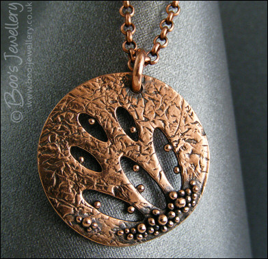 Textured copper pendant drizzled with tiny raindrops