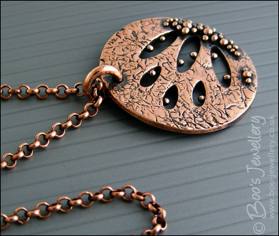 Textured copper pendant drizzled with tiny raindrops