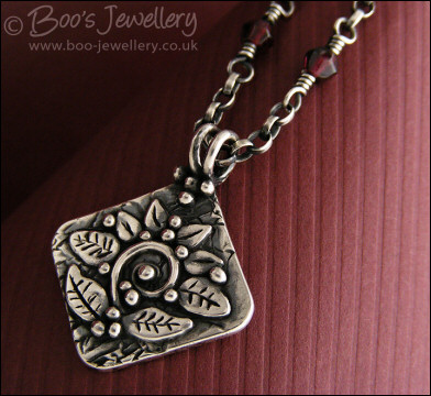 Silver and garnet necklace with square pendant