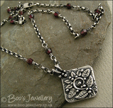 Silver and garnet necklace with square pendant