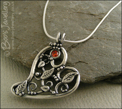 Fine silver filigree heart pendant filled with leaves and scrolls
