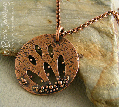 Textured copper pendant drizzled with tiny raindrops