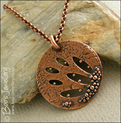 Textured copper pendant drizzled with tiny raindrops