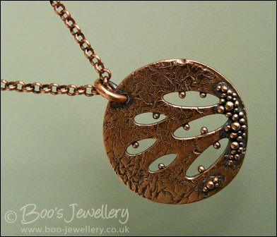 Textured copper pendant drizzled with tiny raindrops