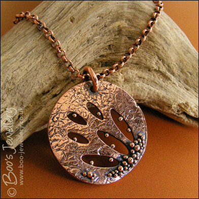 Textured copper pendant drizzled with tiny raindrops