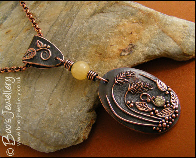 Copper and honey jade pendant with leaves and grasses