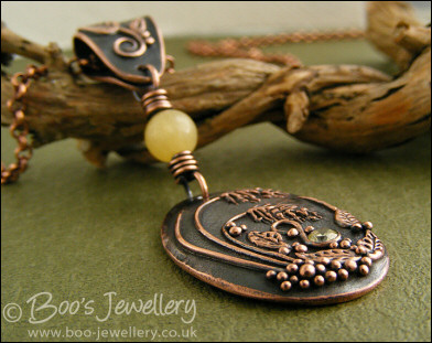 Copper and honey jade pendant with leaves and grasses