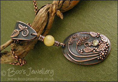 Copper and honey jade pendant with leaves and grasses