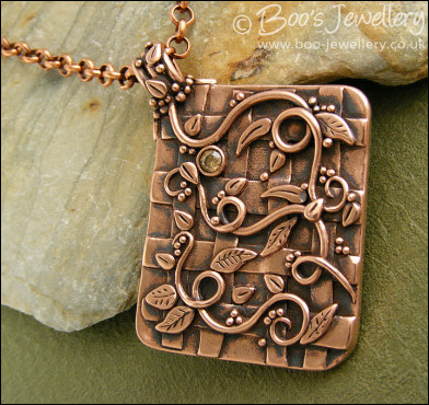 Copper garden trellis pendant festooned with vines and leaves