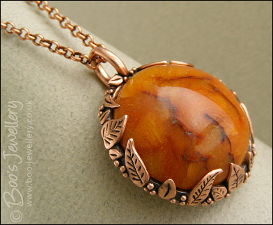 Faux amber cabochon and leaf theme pendant
