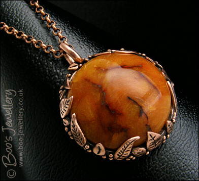 Faux amber cabochon and leaf theme pendant