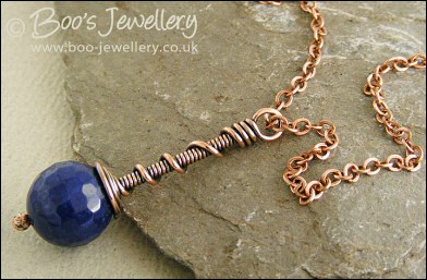 Deep blue faceted jade coil on coil pendant