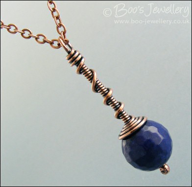 Deep blue faceted jade coil on coil pendant
