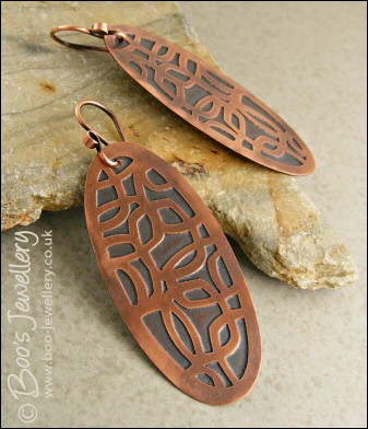 Oval shaped etched copper earrings with retro geometric design