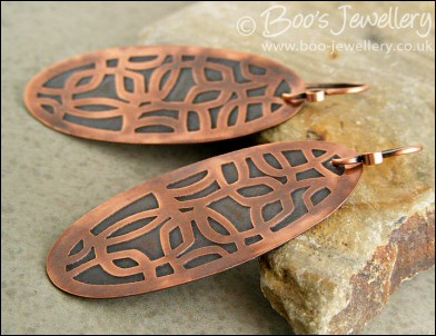 Oval shaped etched copper earrings with retro geometric design