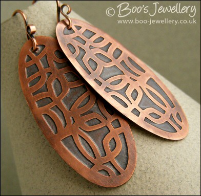 Oval shaped etched copper earrings with retro geometric design