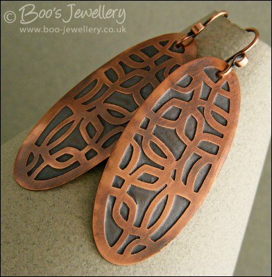 Oval shaped etched copper earrings with retro geometric design