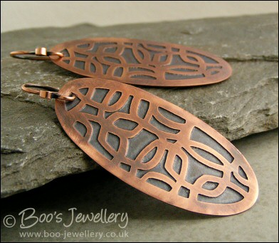 Oval shaped etched copper earrings with retro geometric design