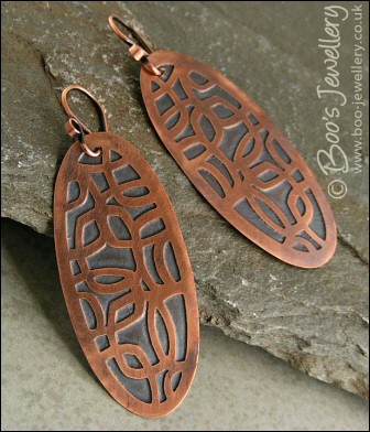 Oval shaped etched copper earrings with retro geometric design