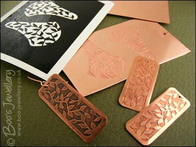 Fan shaped etched copper earrings with scroll design