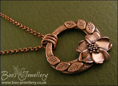 Circle pendant with sculpted wild rose