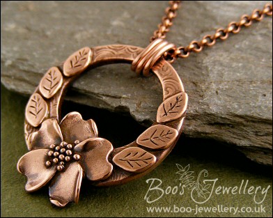 Circle pendant with sculpted wild rose