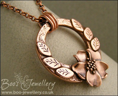 Circle pendant with sculpted wild rose