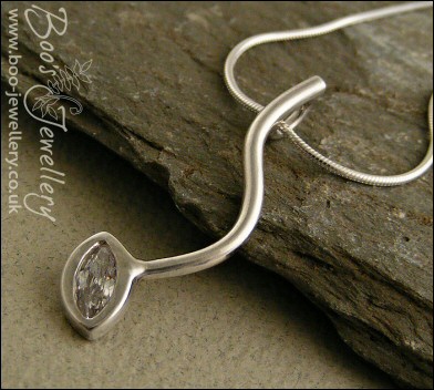 Silver curve pendant set with marquise shaped cubic zirconia
