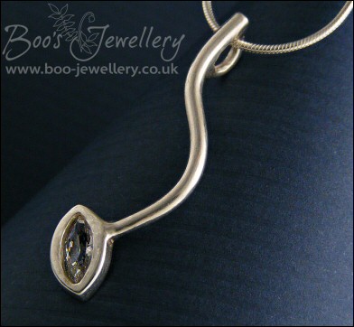 Silver curve pendant set with marquise shaped cubic zirconia