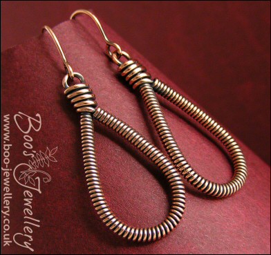 Long teardrop coiled loop earrings in antiqued copper