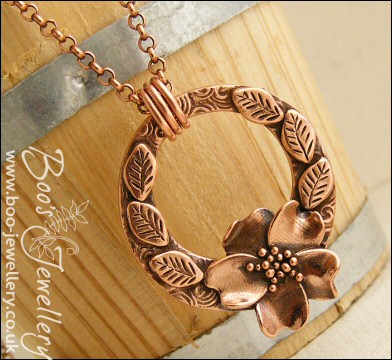 Circle pendant with sculpted wild rose