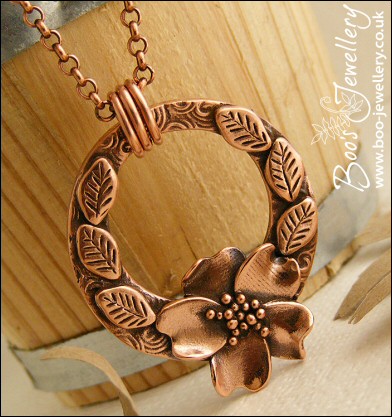 Circle pendant with sculpted wild rose