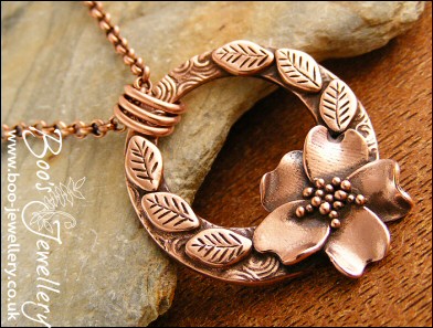 Circle pendant with sculpted wild rose