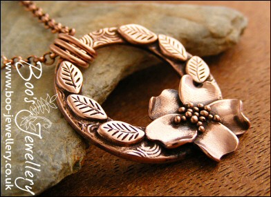 Circle pendant with sculpted wild rose