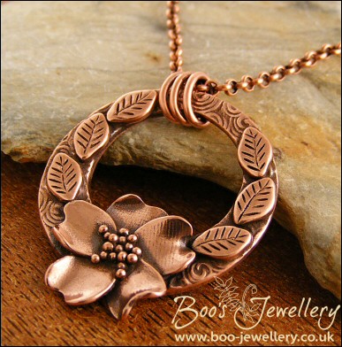 Circle pendant with sculpted wild rose