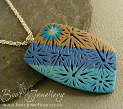 Polymer clay blue tones carved pendant on rope chain