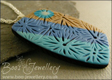 Polymer clay blue tones carved pendant on rope chain