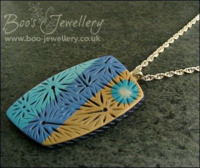 Polymer clay blue tones carved pendant on rope chain