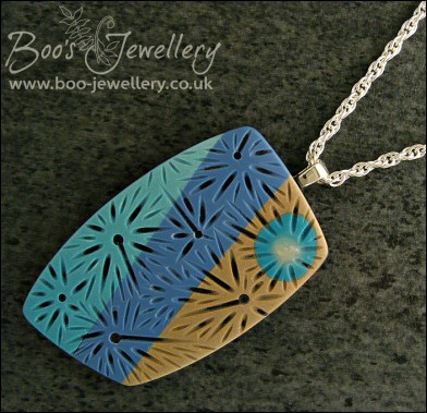 Polymer clay blue tones carved pendant on rope chain