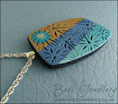 Polymer clay blue tones carved pendant on rope chain