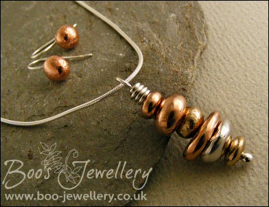 Mixed metal pebble stack pendant on silver chain with matching earrings