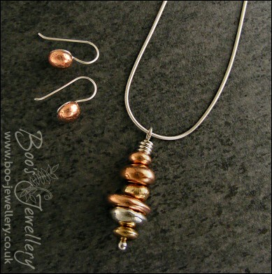 Mixed metal pebble stack pendant on silver chain with matching earrings
