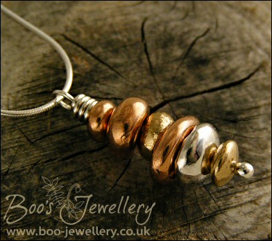 Mixed metal pebble stack pendant on silver chain with matching earrings