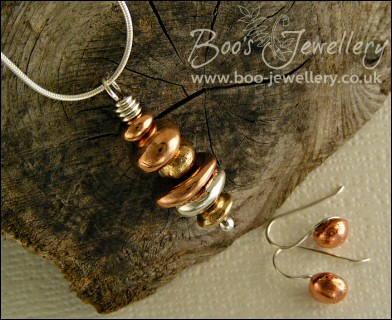 Mixed metal pebble stack pendant on silver chain with matching earrings