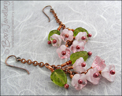 Chain earrings with pink glass blossoms on rosy red copper
