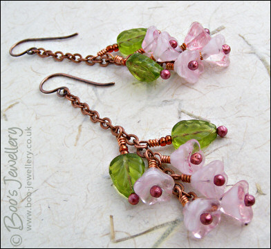 Chain earrings with pink glass blossoms on rosy red copper