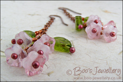 Chain earrings with pink glass blossoms on rosy red copper
